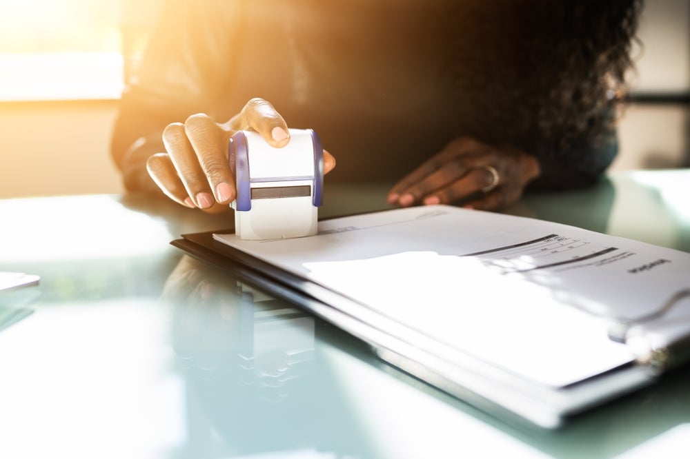Black woman notarizing a document