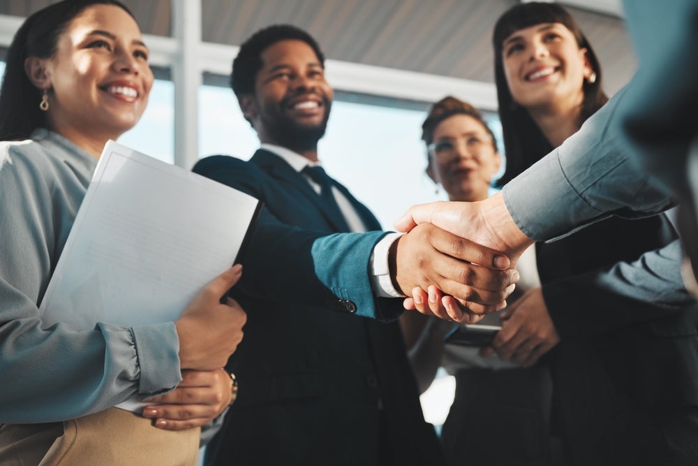 professional and diverse group greeting each other